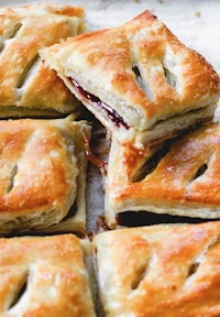 a stack of pastries with jam on top