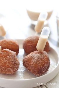 a plate of donuts with milk and sugar on top