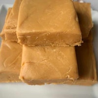 a stack of peanut butter fudge on a white plate