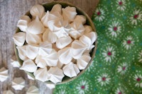 white meringue in a bowl on a green cloth