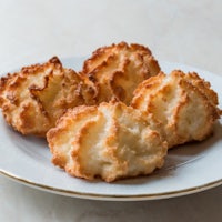 four macaroons on a white plate